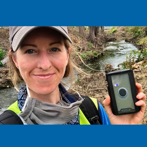 Woman holding Trimble device